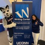 Student and Jonathan Husky pose with the W sign
